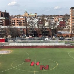 Newtown High School Athletics Field - View of Newtown Field from the parking lot of Queens Center, with Newtown itself towering above the rest. Photo taken in 2019.