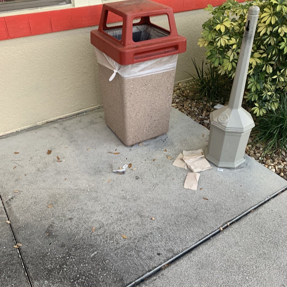 Look at the grease on the sidewalk. Trash all around