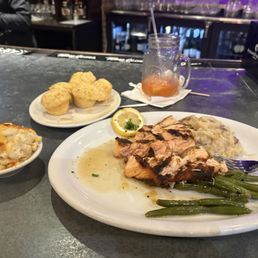 Peach salmon, mashed potato, green beans side of corn muffins and mac&cheese plus glass one of Down South