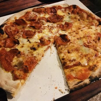 Pizzeria Manglar - Cuatro quesos pizza with pepperoni to half of it - Pizza Near Me - Tulum, ROO Pizzeria Manglar - Cuatro quesos pizza with pepperoni to half of it - Pizza Near Me - Tulum, ROO