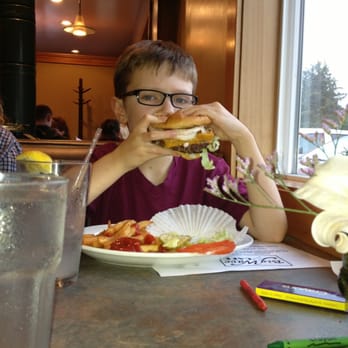 Big Wave Cafe - 9 year old tearing up on a burger, in case kids don't want fish. - Seafood Near Me - Manzanita, Oregon Big Wave Cafe - 9 year old tearing up on a burger, in case kids don't want fish. - Seafood Near Me - Manzanita, Oregon