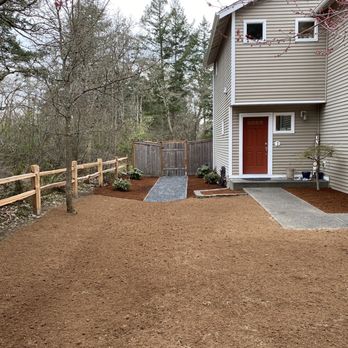 Tran's Landscaping & Gardening - a gravel driveway with a wooden fence - Landscaping Near Me