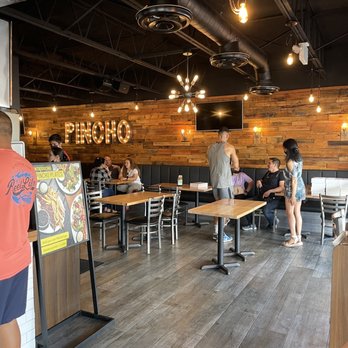 PINCHO - Seating area, it's the lady selling donuts in their boxes. - Burgers Near Me - Hialeah, Florida