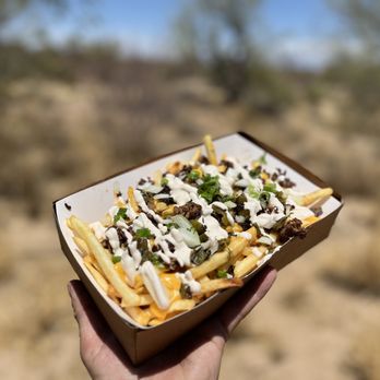National Eats - Small Bodega Fries - Adobo seasoned ground beef, hatch chiles, diced onion, chipotle-lime crema with a green onion garnish. - Food Trucks Near Me - Sahuarita, Arizona National Eats - Small Bodega Fries - Adobo seasoned ground beef, hatch chiles, diced onion, chipotle-lime crema with a green onion garnish. - Food Trucks Near Me - Sahuarita, Arizona