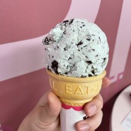 Single scoop of mint chip ice cream on a cake cone