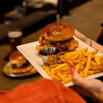 Bricktown Brewery - a person holding a plate of food - Breweries Near Me - Enid, Oklahoma Bricktown Brewery - a person holding a plate of food - Breweries Near Me - Enid, Oklahoma