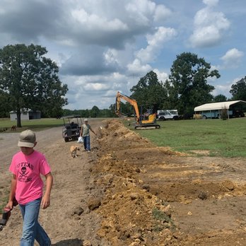 New Oak Construction - a man walking on a dirt road - Excavation Services Near Me New Oak Construction - a man walking on a dirt road - Excavation Services Near Me