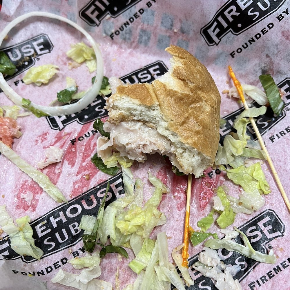 a half eaten sandwich on a wrapper a half eaten sandwich on a wrapper