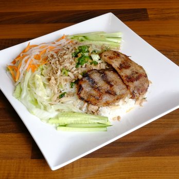 Madame Ly - a plate of food on a wooden table - Vietnamese Near Me - Montreal, Quebec Madame Ly - a plate of food on a wooden table - Vietnamese Near Me - Montreal, Quebec
