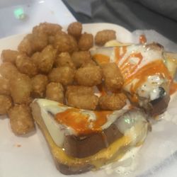 The Rowdy Rooster Bar and Grille - Grilled cheese smoothered with buffalo and ranch and side of tater tot's.