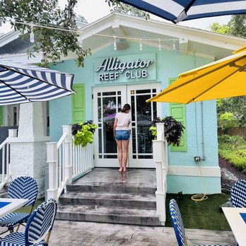 Alligator Reef Club - a woman walking out of the door - Bars Near Me - Melbourne, Florida
