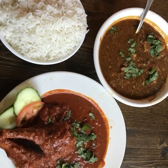 Kathakali - Spicy lamb chops (bottom left) and nalla molagu chicken curry (top right) served with rice - Indian Near Me - Kirkland, Washington Kathakali - Spicy lamb chops (bottom left) and nalla molagu chicken curry (top right) served with rice - Indian Near Me - Kirkland, Washington