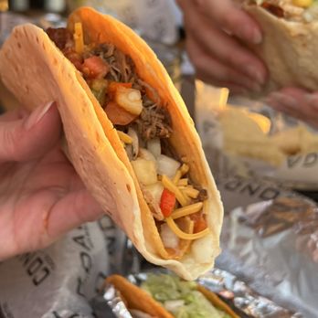 Condado Tacos - two hands holding a taco - Tacos Near Me - Saint Louis, Missouri Condado Tacos - two hands holding a taco - Tacos Near Me - Saint Louis, Missouri