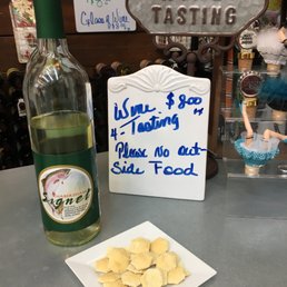 a bottle of wine and a plate of food a bottle of wine and a plate of food