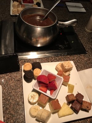 Photo of The Melting Pot - Raleigh, NC, US. Flaming turtle chocolate with desert plate.