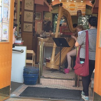 The Soap Opera - Harp! - Inside a store, a large wooden harp is positioned near the entrance, with customers and staff visible around it. - Cosmetics & Beauty Supply Near Me - Madison, Wisconsin