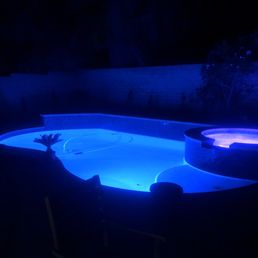 a pool and spa at night a pool and spa at night
