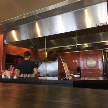 Genghis Grill - a chef preparing food in a commercial kitchen - Mongolian Near Me - Fort Worth, Texas