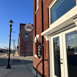 a brick building with a sign that says local a brick building with a sign that says local