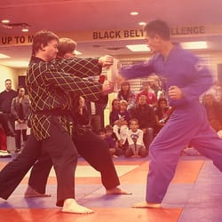 Yuen's Family Martial Arts - Paul Ikoma during his blackbelt test at Yuen's Martial Arts doing a board break with a reverse punch. *Credit - Kyle Bailey Photography