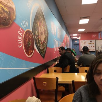 Pita Way - a woman sitting at a table in a restaurant - Mediterranean Near Me - Fenton, Michigan Pita Way - a woman sitting at a table in a restaurant - Mediterranean Near Me - Fenton, Michigan