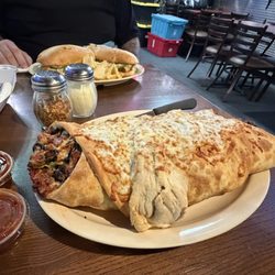 Pike's Pub - "Garbage pizza" sausage roll, grilled buffalo chicken grinder.