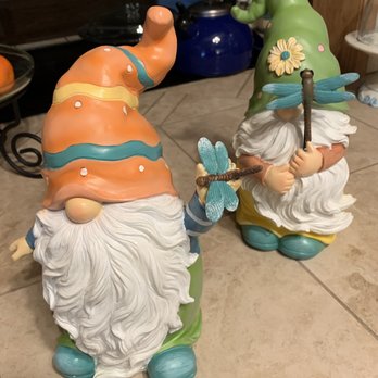 TJ Maxx - I'm in love! About 12" tall and only $10 each! - Two ceramic garden gnome statues with whimsical hats and beards, each holding a dragonfly, placed on a tiled kitchen counter. - Men's Clothing Near Me - Clovis, California