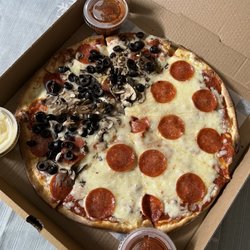Customz Pizzeria - Thin crust pizza w/ pepperoni on whole pie & 1/2 mushroom/black olive. Complimentary sides of red sauce and garlic butter.
