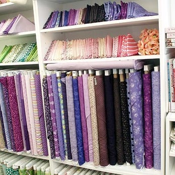 Jennifer's Quilt Shop - The purple section. A lot of fabrics are arranged by color to help you pick similar shades. - Fabric Stores Near Me - Pinckney, Michigan
