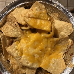 a hand holding a bowl of nachos