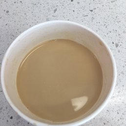 a cup of coffee and a spoon a cup of coffee and a spoon