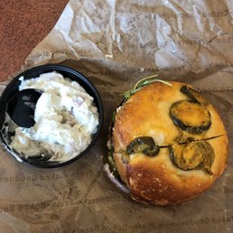 Hummus veggie out on jalapeño cheddar bagel with potato salad