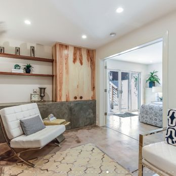 Outerlands Design - a living room with a couch, chair, and bookshelf - General Contractors Near Me - San Francisco, California
