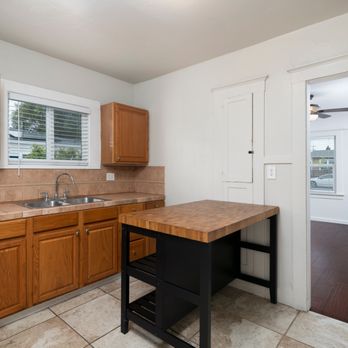 Adam Kelley - Well-lit kitchen with oak cabinets and dual sinks part of a listing by Adam Kelley Real Estate in Carlsbad CA near Discovery Lake . - Real Estate Agents Near Me - Carlsbad, California