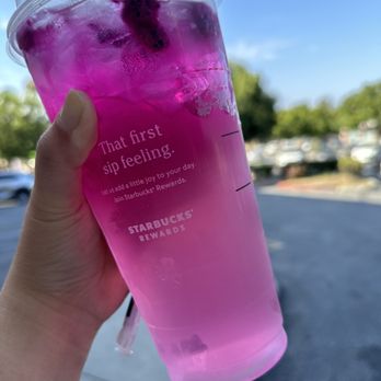 Starbucks - a hand holding a cup of pink liquid - Coffee & Tea Near Me - Pomona, California Starbucks - a hand holding a cup of pink liquid - Coffee & Tea Near Me - Pomona, California