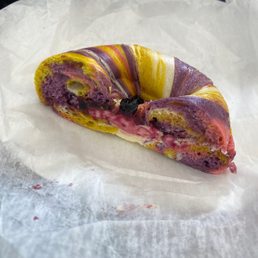 Rainbow bagel with butter and jelly.