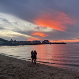 two people walking on the beach two people walking on the beach