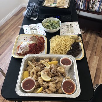 Rossellinis - Family sized calamari (my dad didn't realize how big it would be ), veal parm, filet mignon, pasta, and a Caesar salad - Italian Near Me - Daytona Beach, Florida Rossellinis - Family sized calamari (my dad didn't realize how big it would be ), veal parm, filet mignon, pasta, and a Caesar salad - Italian Near Me - Daytona Beach, Florida