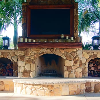Triskell Restorations - Outdoor living space. Custom rustic wooden mantel with distressed-leather TV frame. - General Contractors Near Me - Vista, California Triskell Restorations - Outdoor living space. Custom rustic wooden mantel with distressed-leather TV frame. - General Contractors Near Me - Vista, California