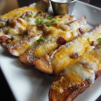 Jersey's Great Food & Spirits - JoJo Potatoes topped with melted cheese, bacon bits, and green onion - Sports Bars Near Me - Shoreline, Washington