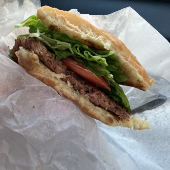 PLNT Burger - PLNT Burger with lettuce and tomato on a warm bun. - Vegan Near Me - Silver Spring, Maryland PLNT Burger - PLNT Burger with lettuce and tomato on a warm bun. - Vegan Near Me - Silver Spring, Maryland