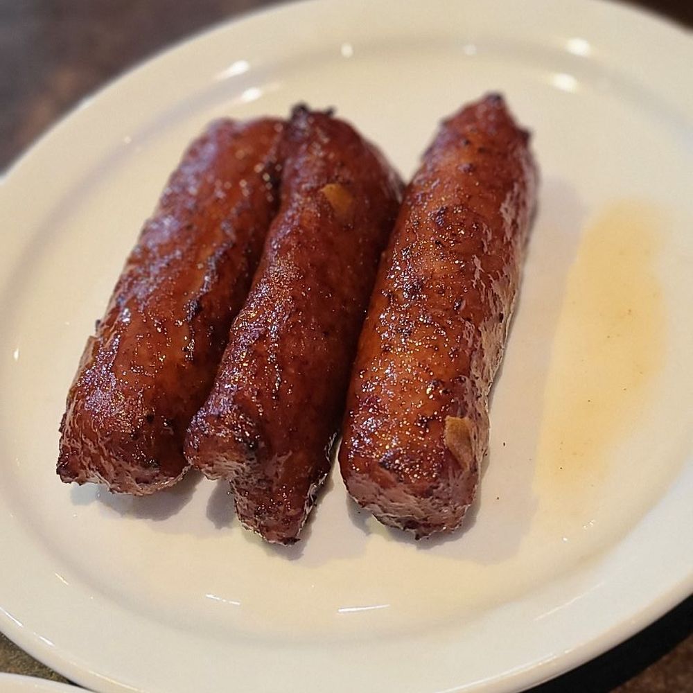 Chowkeni - three sausages on a white plate - Food Trucks Near Me