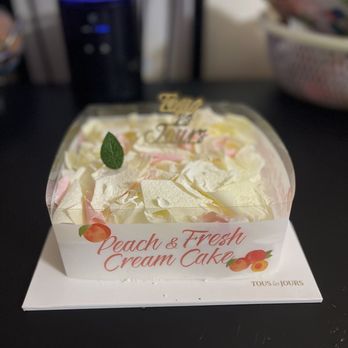 Tous Les Jours - a cake in a plastic container - Coffee & Tea Near Me - Seattle, Washington