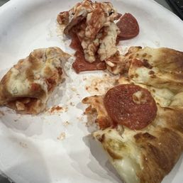 Not fully cooked dough and cheese. I ate the pepperoni with the nice stuffed crust on the right side. Not fully cooked dough and cheese. I ate the pepperoni with the nice stuffed crust on the right side.
