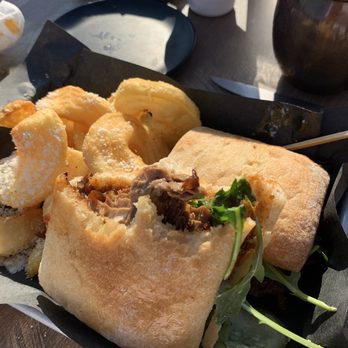 Rapid River Stillhouse - Brisket Sandwich with Parmesan Sidewinders - American Near Me - Grand Rapids, Michigan Rapid River Stillhouse - Brisket Sandwich with Parmesan Sidewinders - American Near Me - Grand Rapids, Michigan
