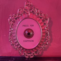 Outside the bathroom to request champagne. I don't think it actually works