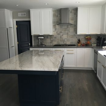 Picasso Construction - a kitchen with white cabinets and marble countertops - General Contractors Near Me - Westlake Village, California Picasso Construction - a kitchen with white cabinets and marble countertops - General Contractors Near Me - Westlake Village, California