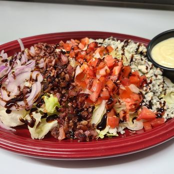 Marlo's Restaurant - Chopped Wedge Salad with blue cheese, red onion, smoky chopped bacon, diced tomatoes, blue cheese dressing and balsamic reduction - Italian Near Me - Crescent City, California Marlo's Restaurant - Chopped Wedge Salad with blue cheese, red onion, smoky chopped bacon, diced tomatoes, blue cheese dressing and balsamic reduction - Italian Near Me - Crescent City, California