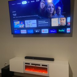 A1TVinstall - 85 inch TV w/ full motion mount + floating fireplace