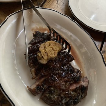 Lamberts Downtown Barbecue - Mustard and Brown Sugar Crusted Niman Ranch Ribeye. Served with roasted garlic - Barbeque Near Me - Austin, Texas Lamberts Downtown Barbecue - Mustard and Brown Sugar Crusted Niman Ranch Ribeye. Served with roasted garlic - Barbeque Near Me - Austin, Texas